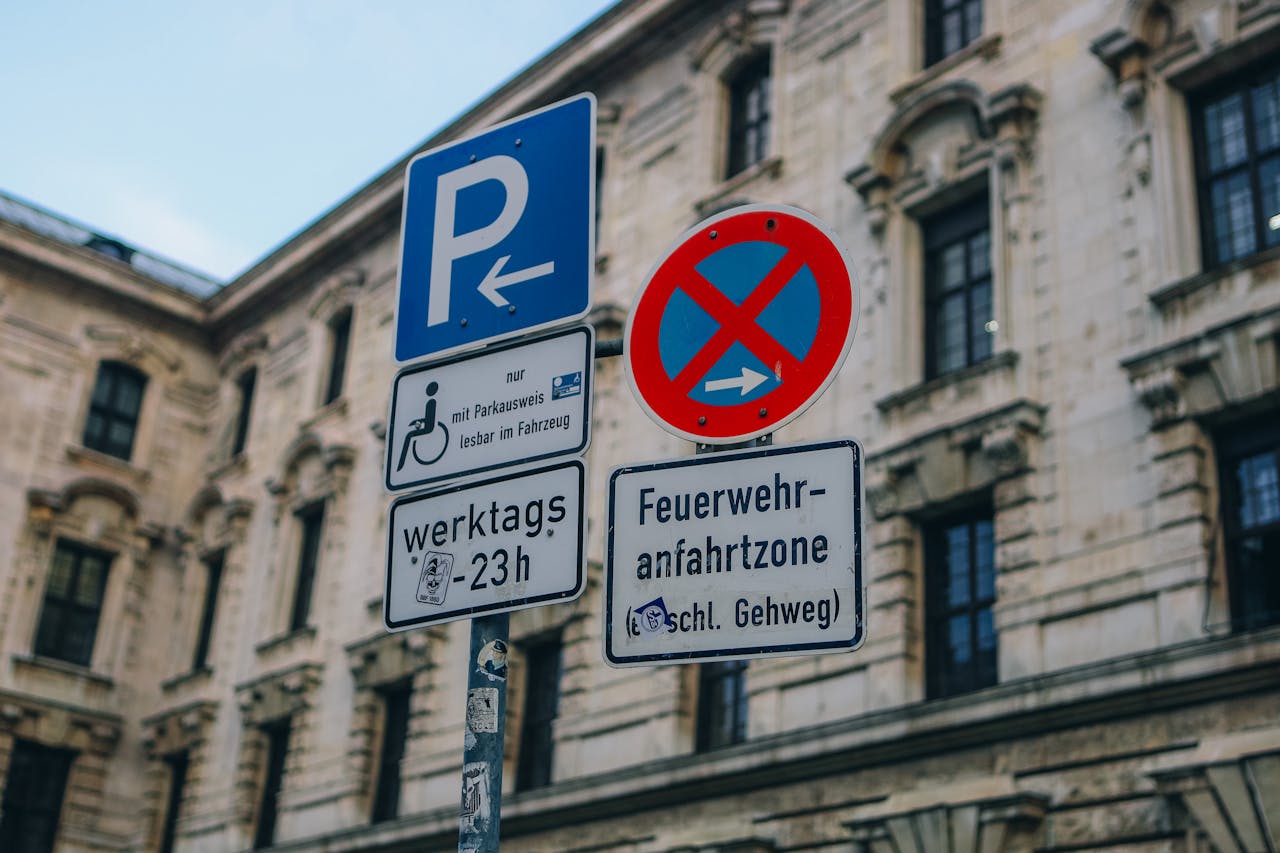 Mastering the First Impression: Your intriguing post title goes here Street signs in front of traditional building facade in urban setting, featuring no parking zone.